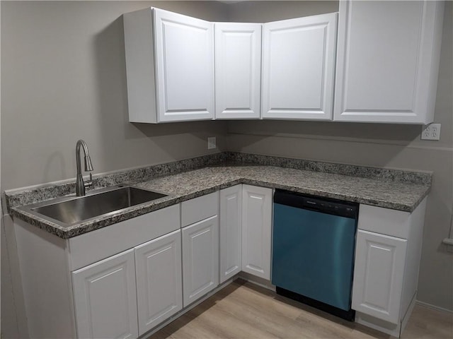 kitchen featuring white cabinetry, dishwasher, light wood-style flooring, and a sink