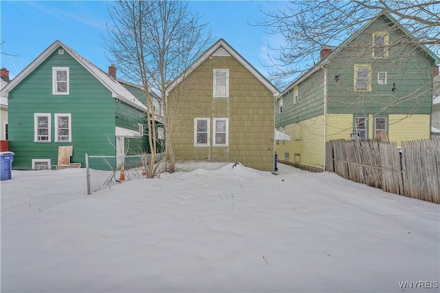 view of snow covered rear of property