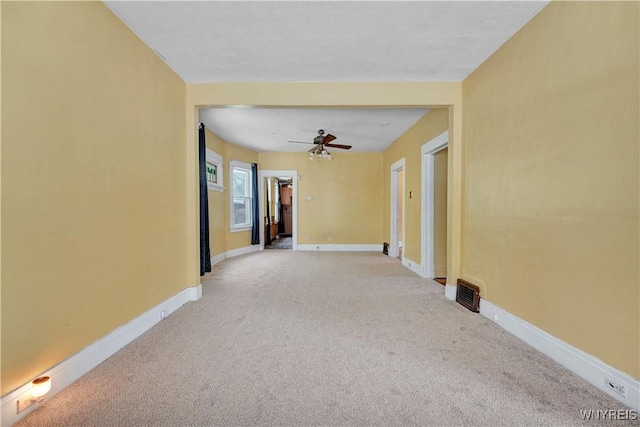 hallway featuring light colored carpet