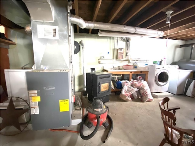 basement with heating unit and washing machine and dryer