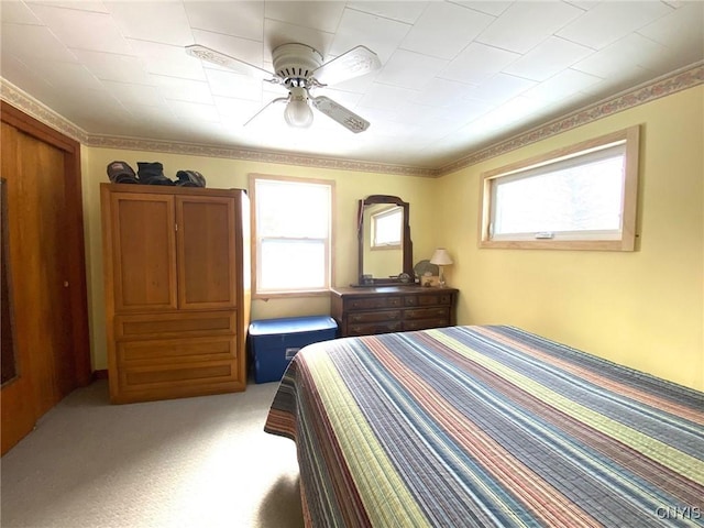 bedroom featuring light colored carpet and ceiling fan