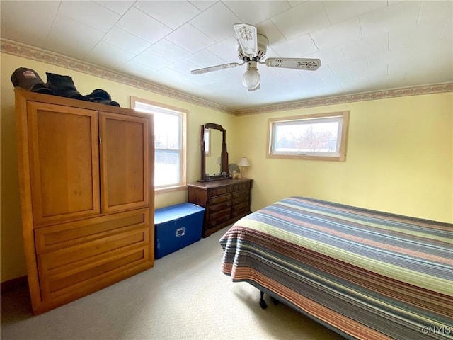 carpeted bedroom with ceiling fan