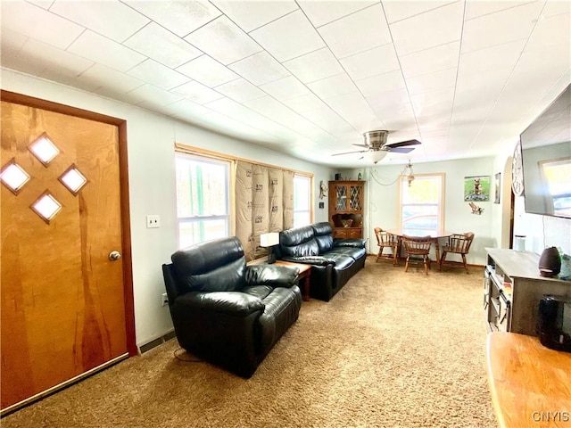 carpeted living room with ceiling fan