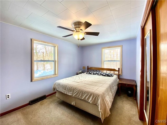 bedroom with light carpet and ceiling fan