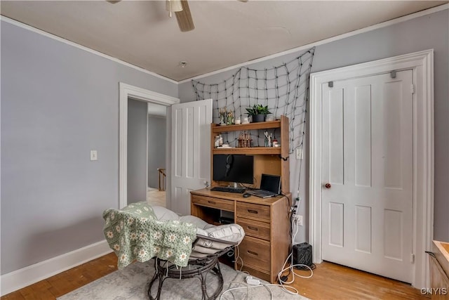 office space featuring ornamental molding, ceiling fan, and light wood-type flooring