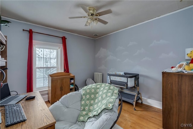 bedroom featuring hardwood / wood-style flooring, ceiling fan, ornamental molding, and radiator