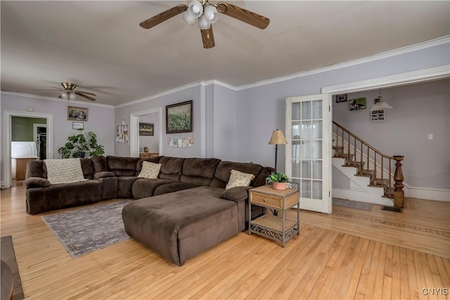 living room with crown molding, ceiling fan, and light hardwood / wood-style floors