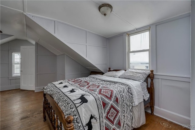 bedroom featuring dark hardwood / wood-style floors and vaulted ceiling