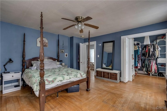 bedroom featuring hardwood / wood-style floors, ceiling fan, and a closet