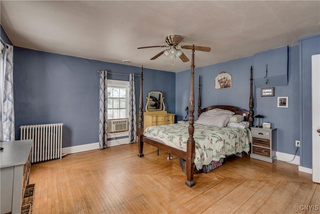 bedroom with hardwood / wood-style flooring, ceiling fan, and radiator