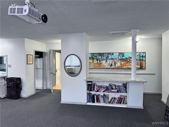 interior space featuring radiator and a textured ceiling