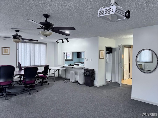 office space with track lighting and a textured ceiling