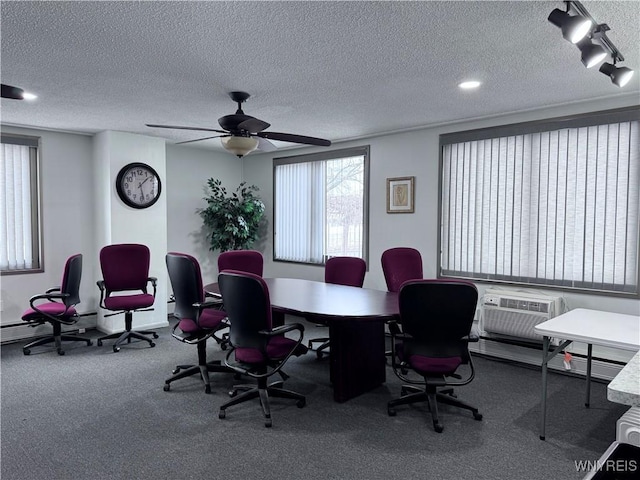 carpeted office with ceiling fan, rail lighting, a wall mounted AC, and a textured ceiling