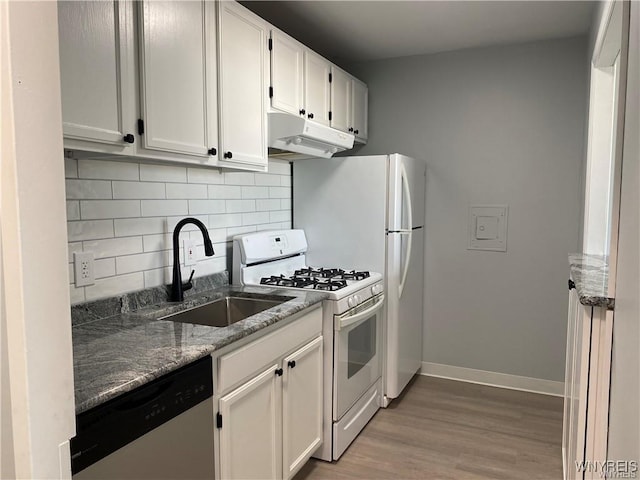 kitchen with tasteful backsplash, white cabinetry, dishwasher, sink, and white gas range oven