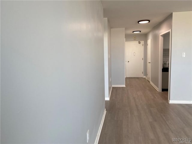 corridor with hardwood / wood-style flooring