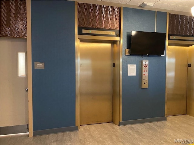 kitchen featuring wood-type flooring and elevator