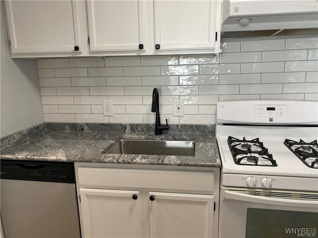 kitchen with sink, dishwasher, dark stone countertops, white cabinets, and white gas range