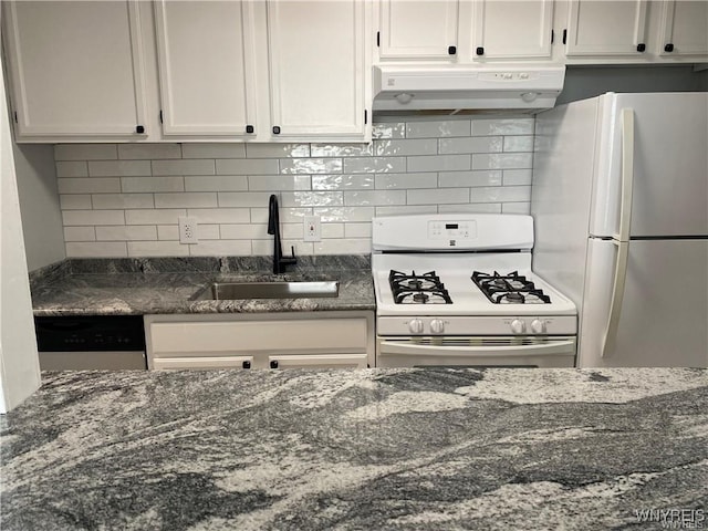 kitchen featuring sink, white cabinetry, white appliances, dark stone counters, and decorative backsplash