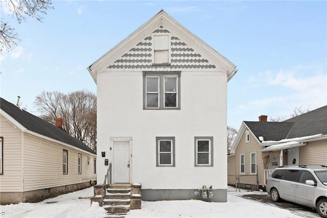 view of snow covered rear of property