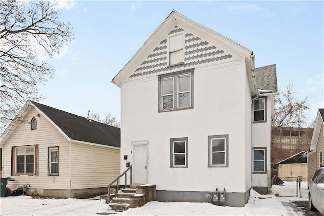 view of snow covered rear of property