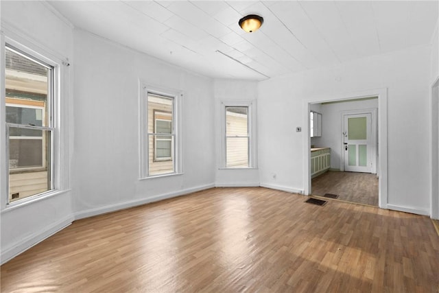 spare room featuring wood-type flooring