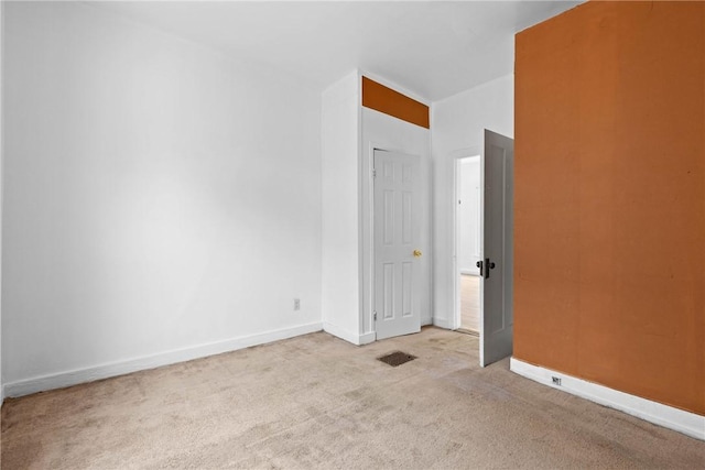 unfurnished room with light colored carpet