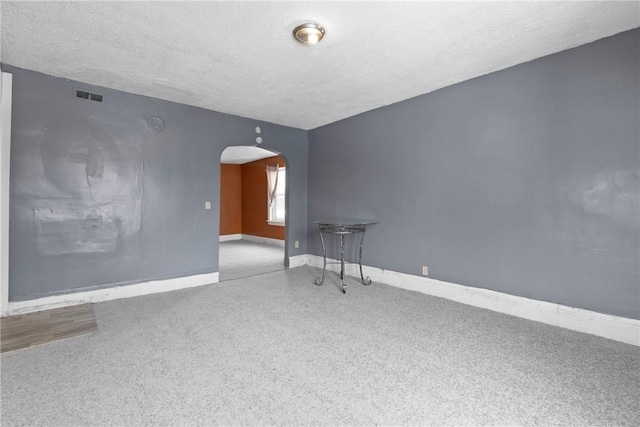 unfurnished room with a textured ceiling