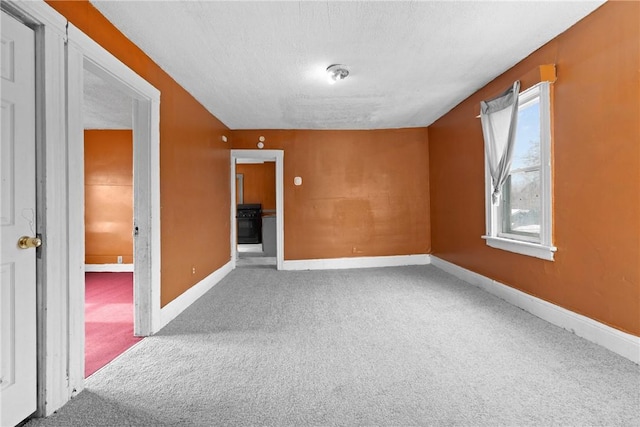 spare room with carpet floors and a textured ceiling