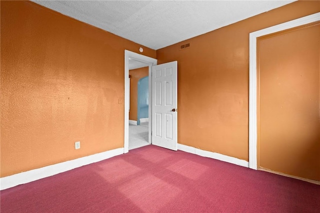 unfurnished bedroom featuring carpet floors and a textured ceiling