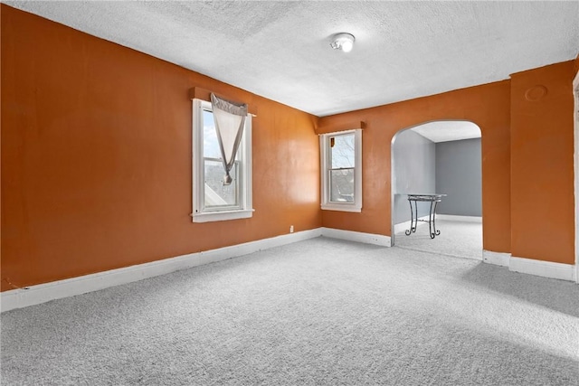 spare room with carpet and a textured ceiling