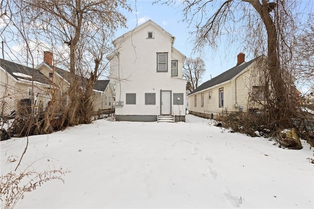 view of snow covered rear of property