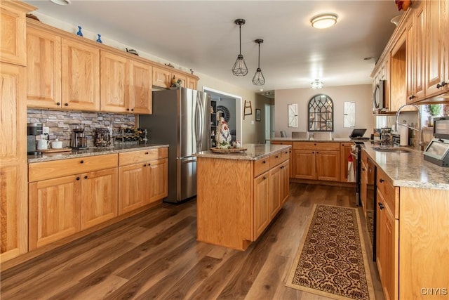 kitchen featuring appliances with stainless steel finishes, decorative light fixtures, dark hardwood / wood-style flooring, a center island, and kitchen peninsula