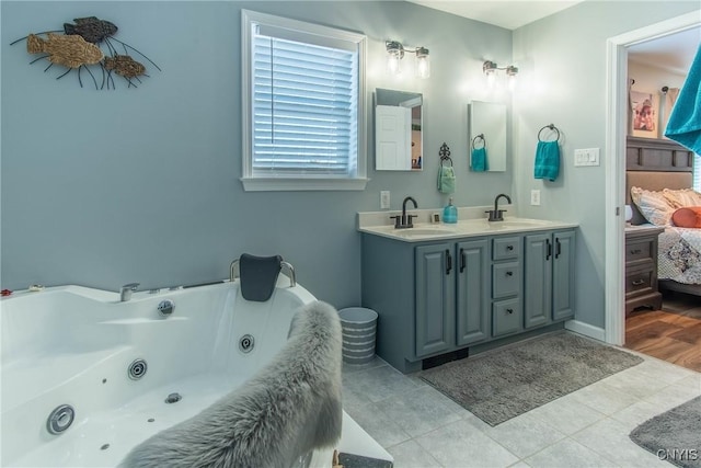 bathroom with vanity, tile patterned flooring, and a washtub