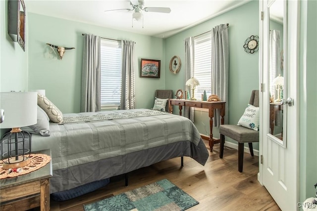 bedroom with light hardwood / wood-style floors and ceiling fan