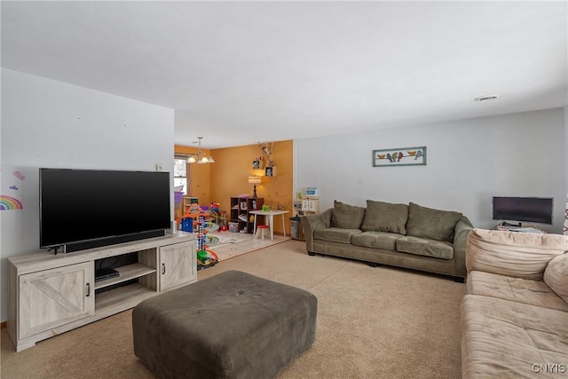 carpeted living room with a chandelier