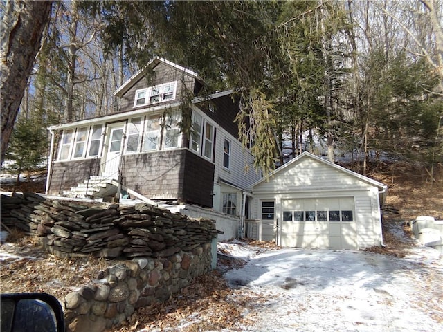 view of front of home featuring a garage and a sunroom