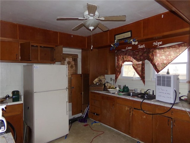 kitchen with sink, backsplash, ceiling fan, and white refrigerator