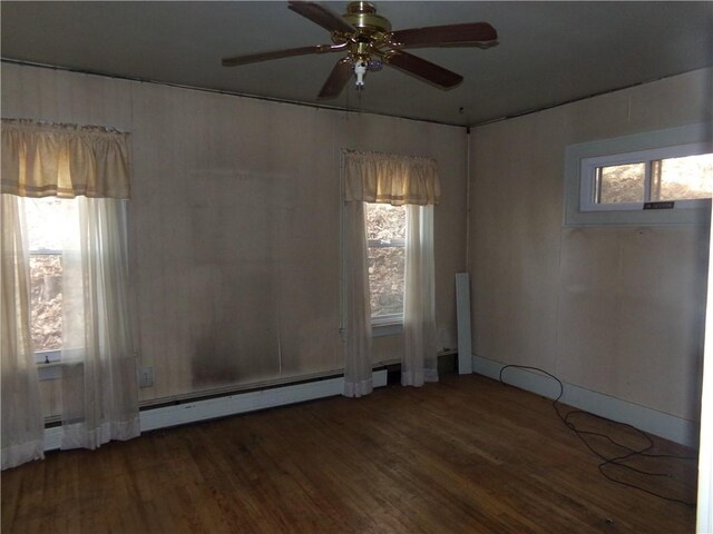 spare room with wood finished floors, plenty of natural light, and a ceiling fan
