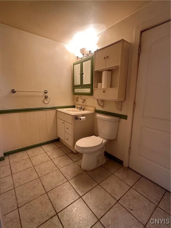 32458 County Route 54, Clayton, NY 13632 - bathroom with tile patterned flooring, vanity, and toilet