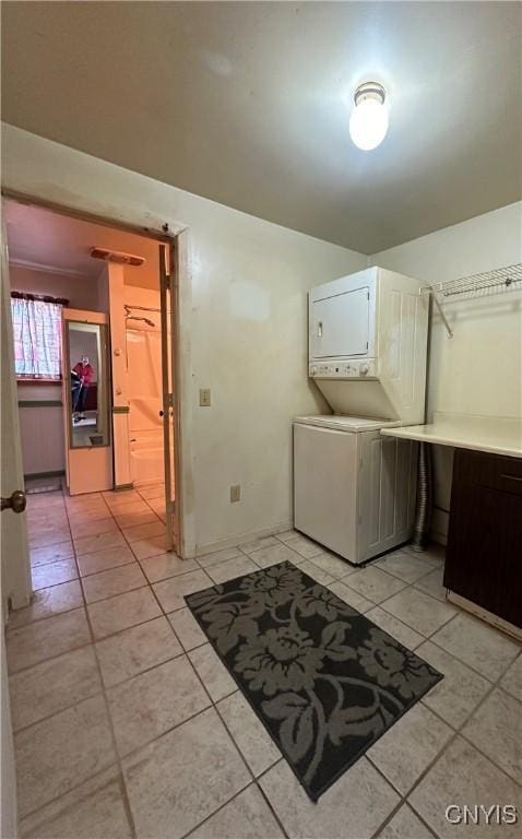 32458 County Route 54, Clayton, NY 13632 - laundry area with light tile patterned floors and stacked washer and clothes dryer