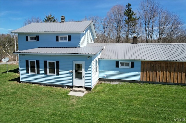 rear view of property with a lawn