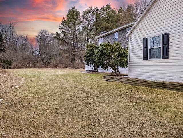 view of yard at dusk