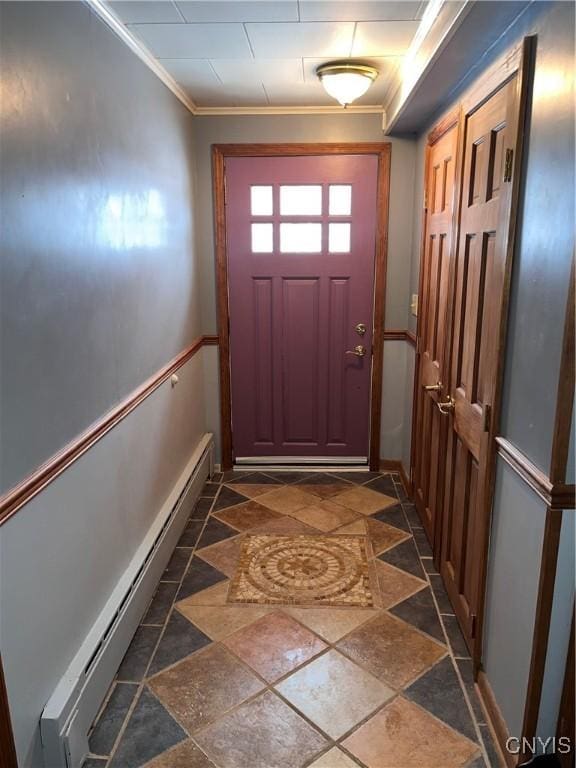 doorway to outside featuring ornamental molding and a baseboard heating unit