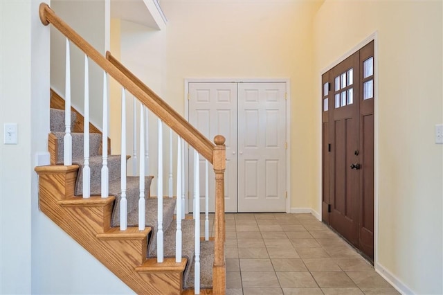 tiled entrance foyer featuring a high ceiling