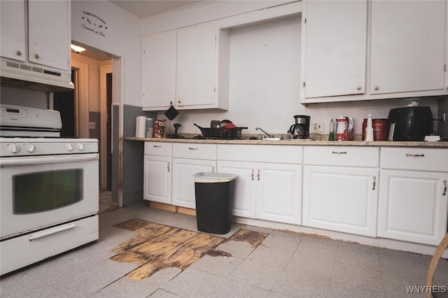 kitchen with white range with gas cooktop and white cabinets