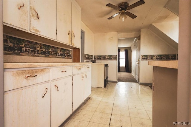 kitchen with white cabinets and ceiling fan