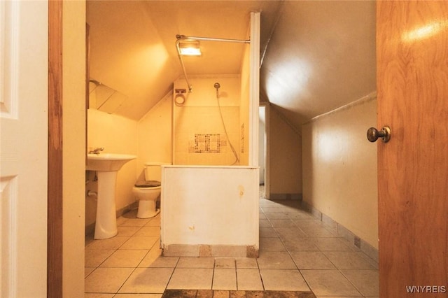 bathroom featuring toilet, tile patterned flooring, and vaulted ceiling