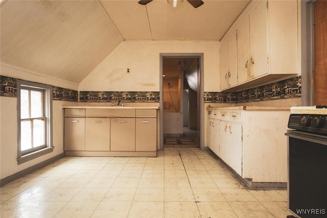 kitchen with lofted ceiling, black range, ceiling fan, and decorative backsplash