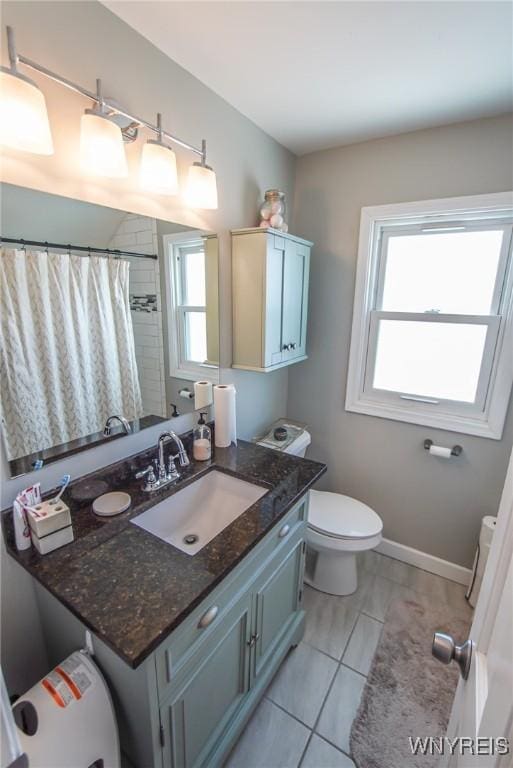 bathroom with vanity, tile patterned floors, and toilet