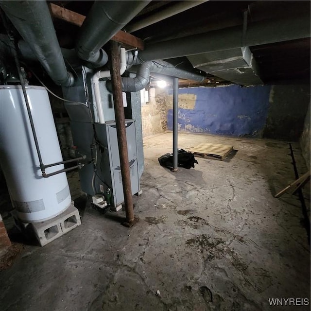 basement featuring heating unit and gas water heater